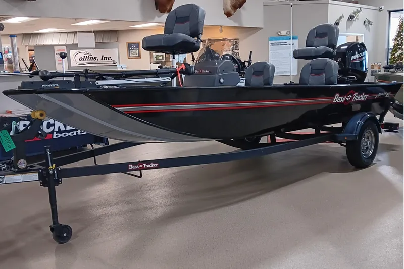 Slide: The Image of 2026 Tracker Bass Tracker Classic XL boat displayed indoors on a trailer. - 4