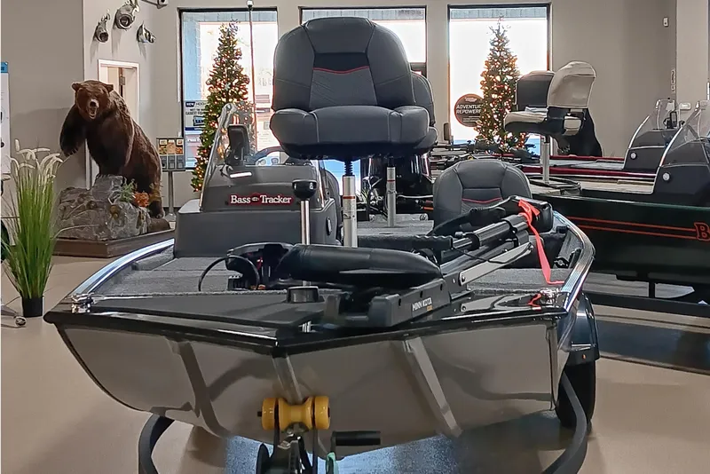 Slide: The Image of 2026 Tracker Bass Tracker Classic XL boat in showroom with holiday decorations and bear display. - 6