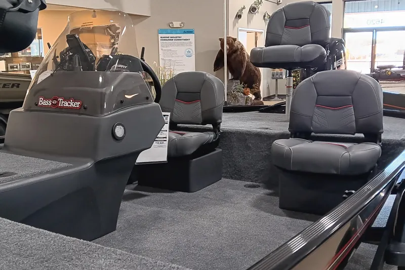 Slide: The Image of 2026 Tracker Bass Tracker Classic XL boat interior with seating and console display. - 8