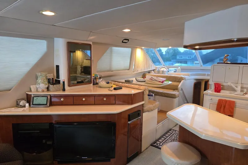 Slide: The Image of Luxurious interior of 1998 Sea Ray 550 Sedan Bridge yacht with spacious seating. - 11
