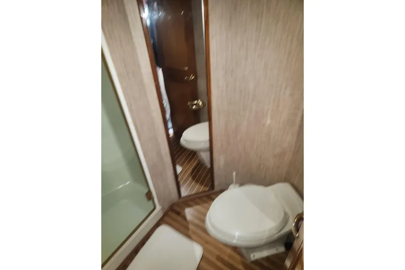 Slide: The Image of 1998 Sea Ray 550 Sedan Bridge interior with cozy dining area and modern amenities. - 19