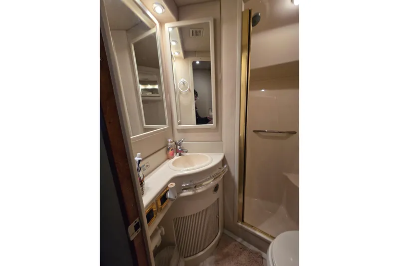 Slide: The Image of Bathroom interior of 1999 Sea Ray 550 Sedan Bridge yacht, featuring shower and toilet. - 38
