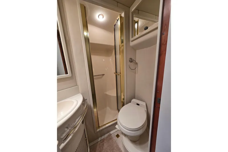 Slide: The Image of Bathroom interior of 1998 Sea Ray 550 Sedan Bridge yacht, featuring sink and shower. - 40
