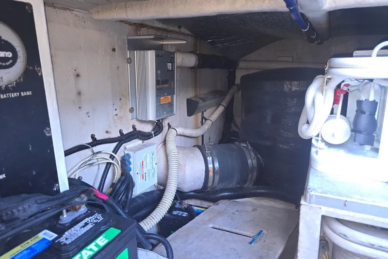 Slide: The Image of Engine room of a 1999 Sea Ray 550 Sedan Bridge with fuel filters and hoses. - 47