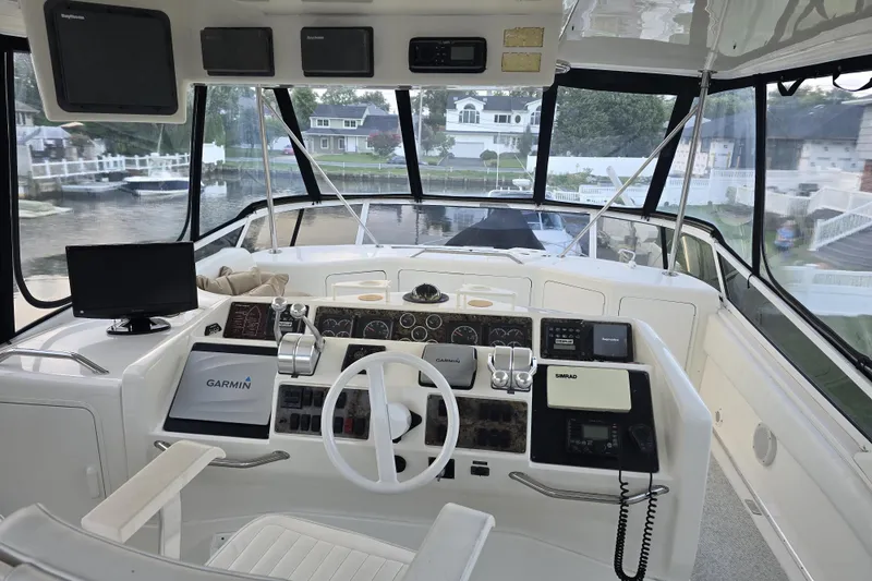 Slide: The Image of 1999 Sea Ray 550 Sedan Bridge helm with navigation equipment and panoramic view. - 5