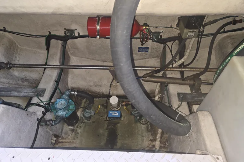 Slide: The Image of Engine room of a 1999 Sea Ray 550 Sedan Bridge yacht, showcasing mechanical components. - 51