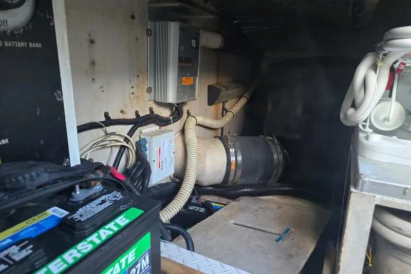 Slide: The Image of Battery compartment of a 1999 Sea Ray 550 Sedan Bridge with wiring and components. - 56