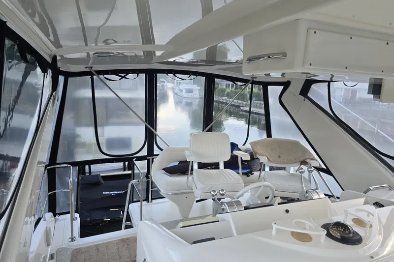 Slide: The Image of 1998 Sea Ray 550 Sedan Bridge helm with modern controls and panoramic windows. - 6