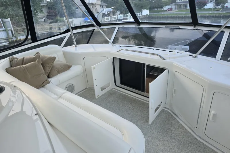 Slide: The Image of 1998 Sea Ray 550 Sedan Bridge helm with modern navigation equipment and waterfront view. - 7