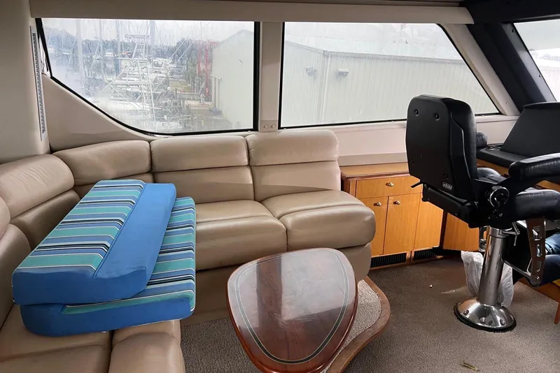 Slide: The Image of Interior of 1998 Sea Ray 550 Sedan Bridge yacht with helm and seating area. - 8