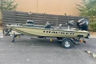 Slide: The Image of 2026 Tracker Pro Team 175 Crappie Edition boat on trailer, parked outdoors. - 6