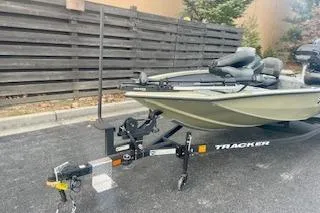 Slide: The Image of 2026 Tracker Pro Team 175 Crappie Edition boat on trailer, parked outdoors. - 7