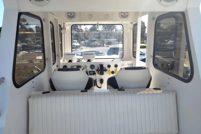 Slide: The Image of Interior of 2021 Custom Pilot House Catamaran with navigation equipment and seating. - 10