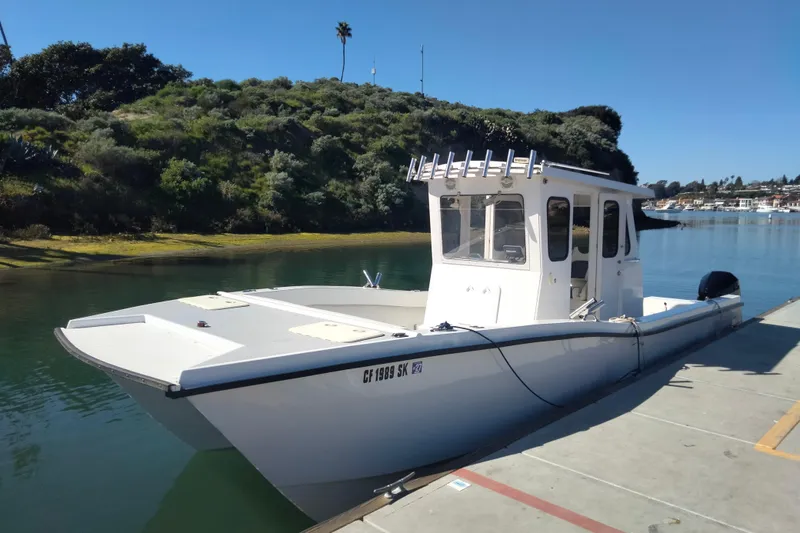 Slide: The Image of Custom 2021 Pilot House Catamaran docked by scenic waterfront. - 13