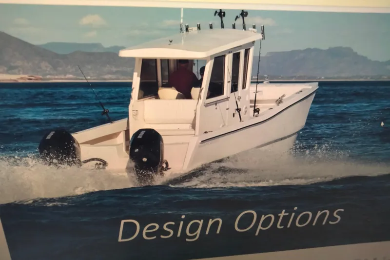 Slide: The Image of 2021 28 Custom Line Pilot House Catamaran cruising on open water. - 4