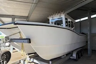 Slide: The Image of 2021 28 Custom Line Pilot House Catamaran in covered storage on trailer. - 5