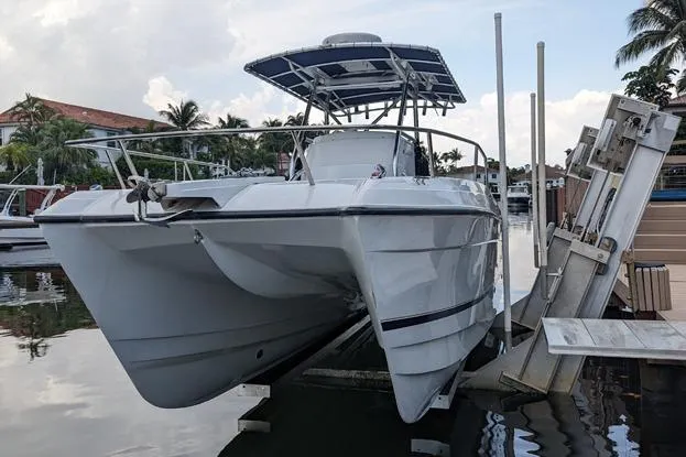 The Image of 2000 Glacier Bay 260 Canyon Runner catamaran docked at marina with palm trees. - 0