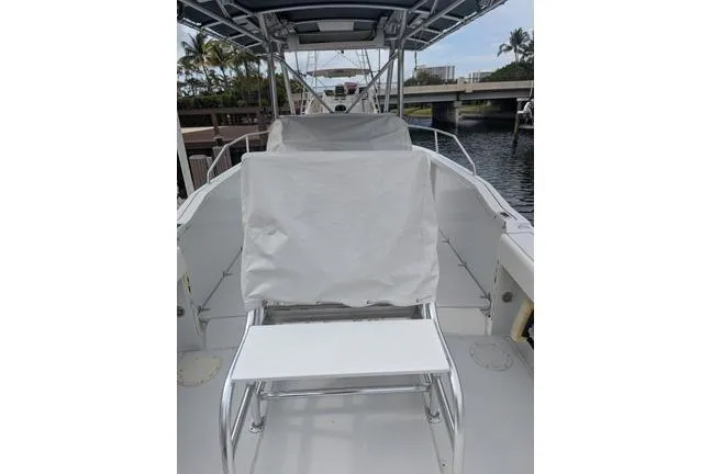 Slide: The Image of 2000 Glacier Bay 260 Canyon Runner boat interior with covered seating and waterway view. - 14