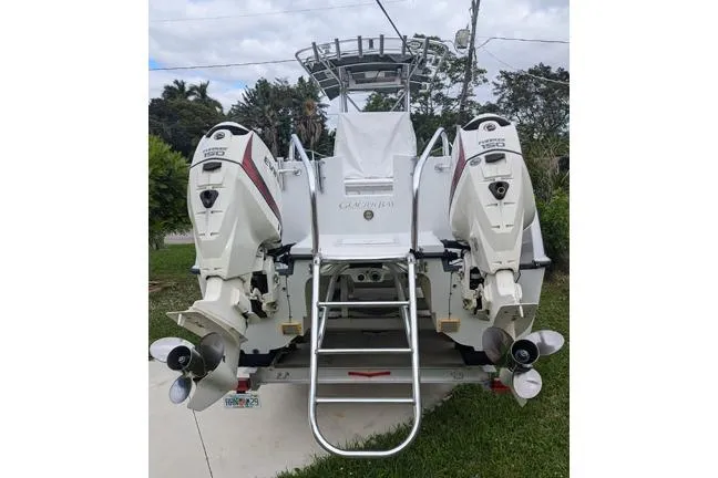 Slide: The Image of 2000 Glacier Bay 260 Canyon Runner boat with dual outboard engines. - 20
