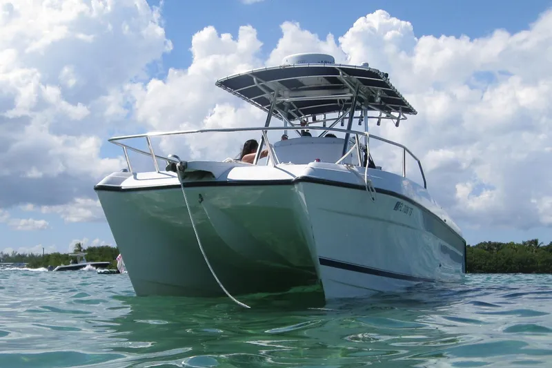 Slide: The Image of 2000 Glacier Bay 260 Canyon Runner boat on clear water under a cloudy sky. - 3