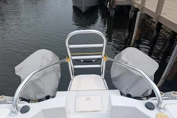 Slide: The Image of 2000 Glacier Bay 260 Canyon Runner boat with covered engines at dock. - 8
