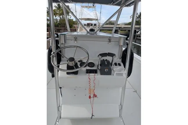 Slide: The Image of 2000 Glacier Bay 260 Canyon Runner boat helm with steering wheel and controls. - 9