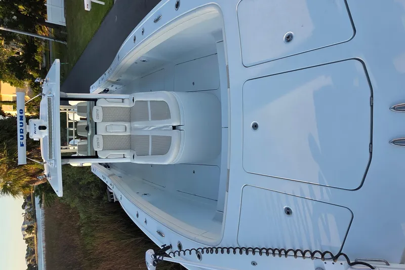 Slide: The Image of 2024 Costa Custom Boats 34 SV interior with Furuno radar, docked by the water. - 10