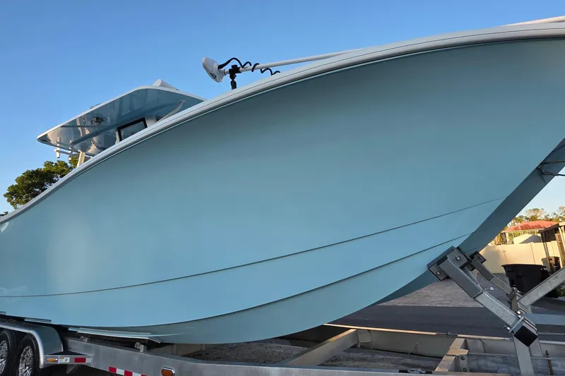 Slide: The Image of 2024 Costa Custom Boats 34 SV docked, showcasing sleek design and luxurious seating. - 11