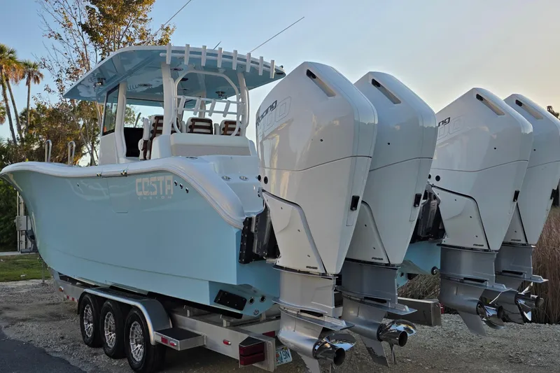 Slide: The Image of 2024 Costa Custom Boats 34 SV, sleek white deck with dual seating and advanced navigation. - 12