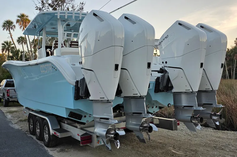 Slide: The Image of 2024 Costa Custom Boats 34 SV with luxurious seating docked near waterfront homes. - 15