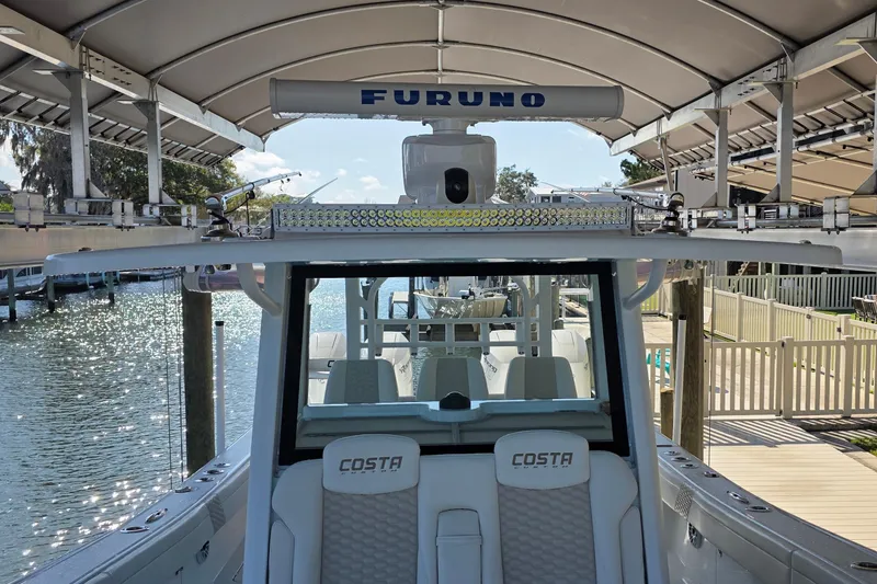 Slide: The Image of 2024 Costa Custom Boats 34 SV with triple Racing 400 engines on water. - 23