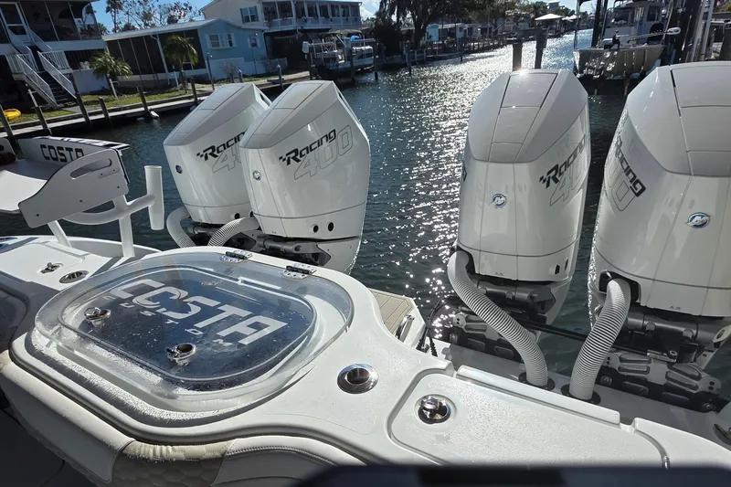 Slide: The Image of 2024 Costa Custom Boats 34 SV with triple Racing 400 engines docked at marina. - 24