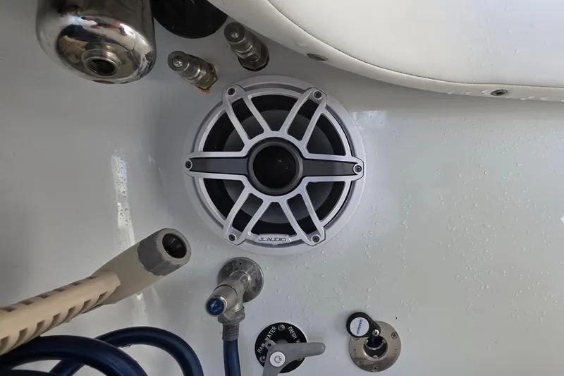 Slide: The Image of Twin Mercury Racing 400 engines on 2024 Costa Custom Boats 34 SV, docked by the water. - 25