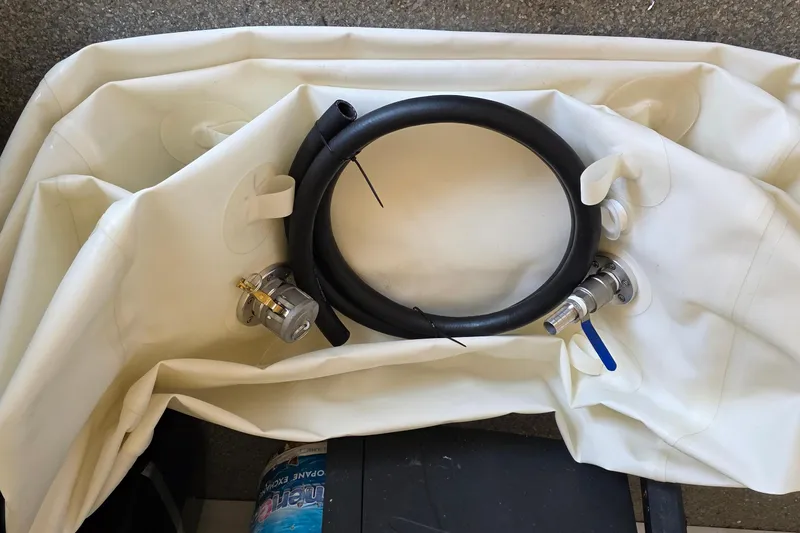 Slide: The Image of 2024 Costa Custom Boats 34 SV storage compartments open on deck by the water. - 28