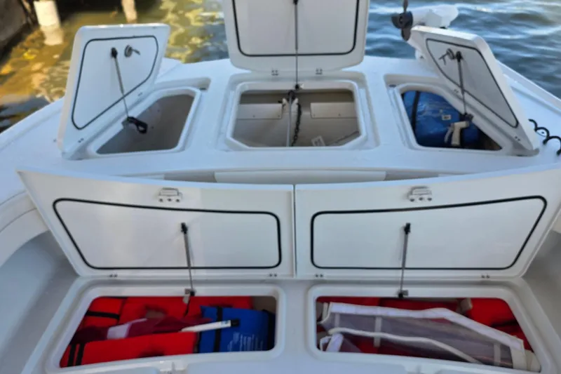 Slide: The Image of 2024 Costa Custom Boats 34 SV storage compartments with life jackets and equipment. - 29