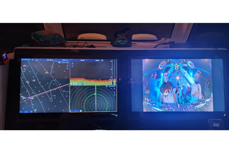 Slide: The Image of 2024 Costa Custom Boats 34 SV dashboard with navigation and entertainment screens. - 31