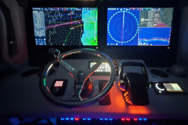 Slide: The Image of 2024 Costa Custom Boats 34 SV dashboard with navigation screens and controls. - 33