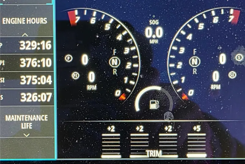 Slide: The Image of Dashboard display of 2024 Costa Custom Boats 34 SV, showing engine hours and voltages. - 34