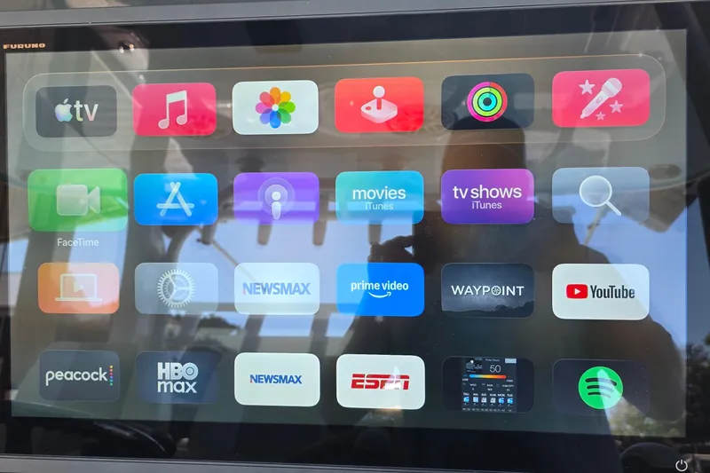 Slide: The Image of Touchscreen display on 2024 Costa Custom Boats 34 SV with various app icons. - 35