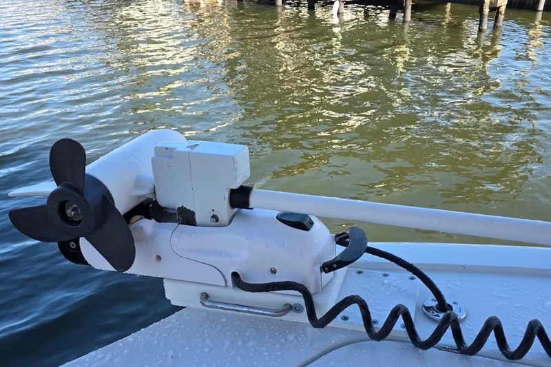 Slide: The Image of Trolling motor on 2024 Costa Custom Boats 34 SV, docked on calm water. - 36