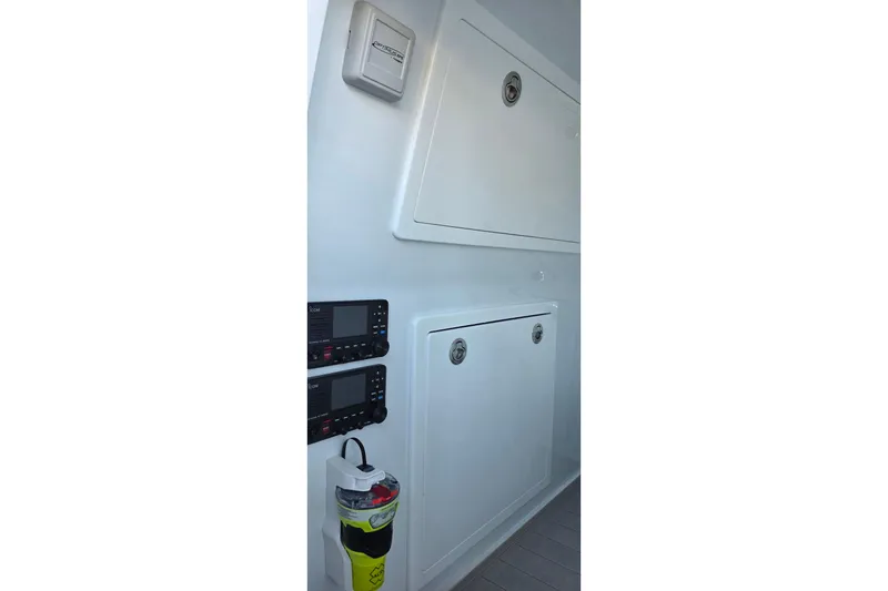 Slide: The Image of Interior view of 2024 Costa Custom Boats 34 SV, featuring control panels and storage compartments. - 41