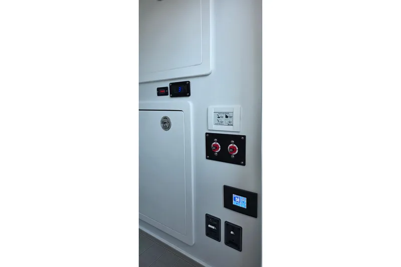 Slide: The Image of 2024 Costa Custom Boats 34 SV control panel with switches and digital display. - 42