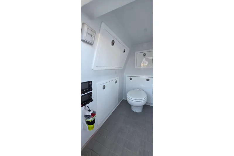 Slide: The Image of 2024 Costa Custom Boats 34 SV interior bathroom with modern fixtures and storage. - 43