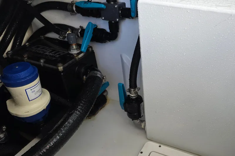 Slide: The Image of 2024 Costa Custom Boats 34 SV engine compartment with hoses and valves. - 48