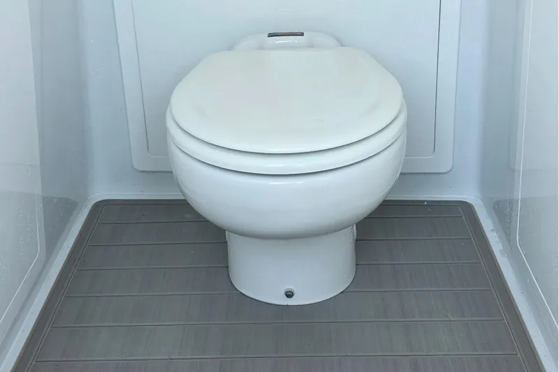 Slide: The Image of 2024 Costa Custom Boats 34 SV interior toilet with modern design and wooden flooring. - 49