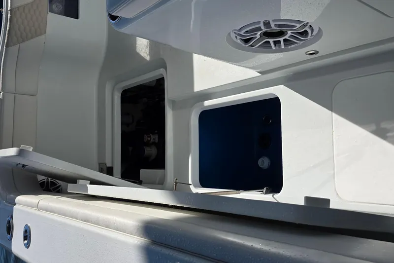 Slide: The Image of 2024 Costa Custom Boats 34 SV interior storage compartments and speaker detail. - 51