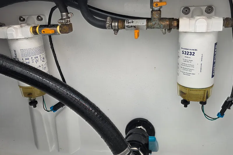 Slide: The Image of Fuel filters and hoses in a 2024 Costa Custom Boats 34 SV engine compartment. - 52