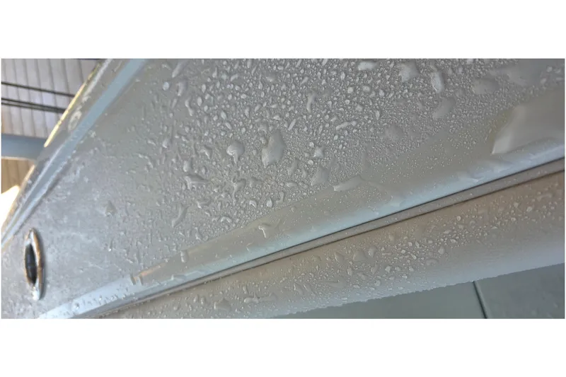 Slide: The Image of 2024 Costa Custom Boats 34 SV hull with water droplets, showcasing sleek design. - 54