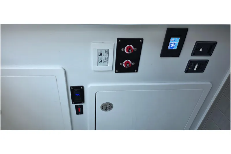 Slide: The Image of Control panel of 2024 Costa Custom Boats 34 SV, featuring switches and digital display. - 55