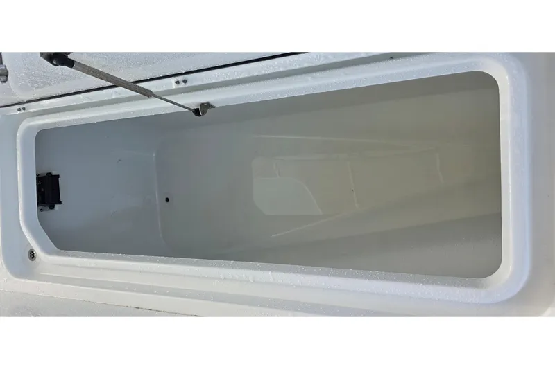 Slide: The Image of 2024 Costa Custom Boats 34 SV storage compartment, open and empty, showcasing interior space. - 57